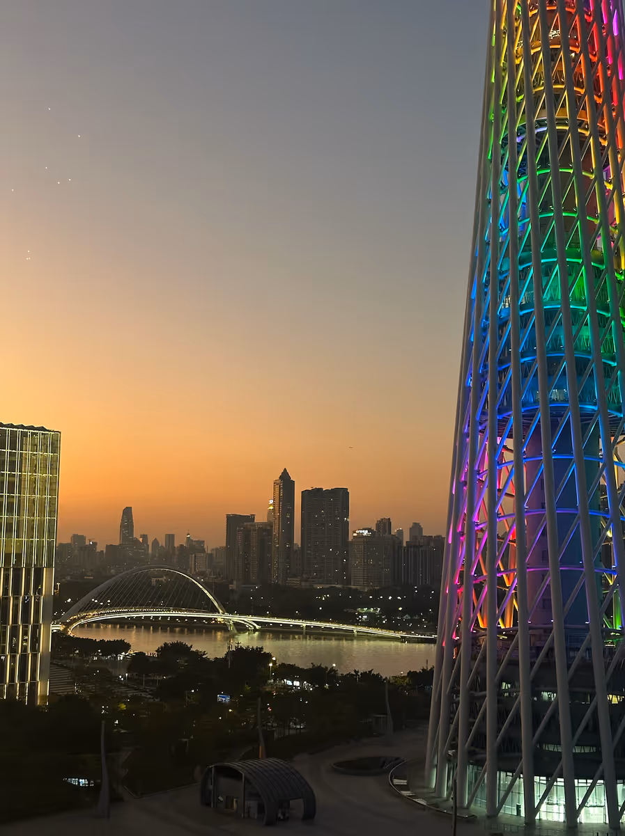 Guangzhou skyline at dusk, Canton Tower lit up in rainbow colors