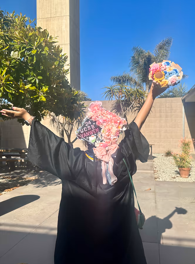 Graduation day at UC Santa Barbara, from behind, tossing a bouquet