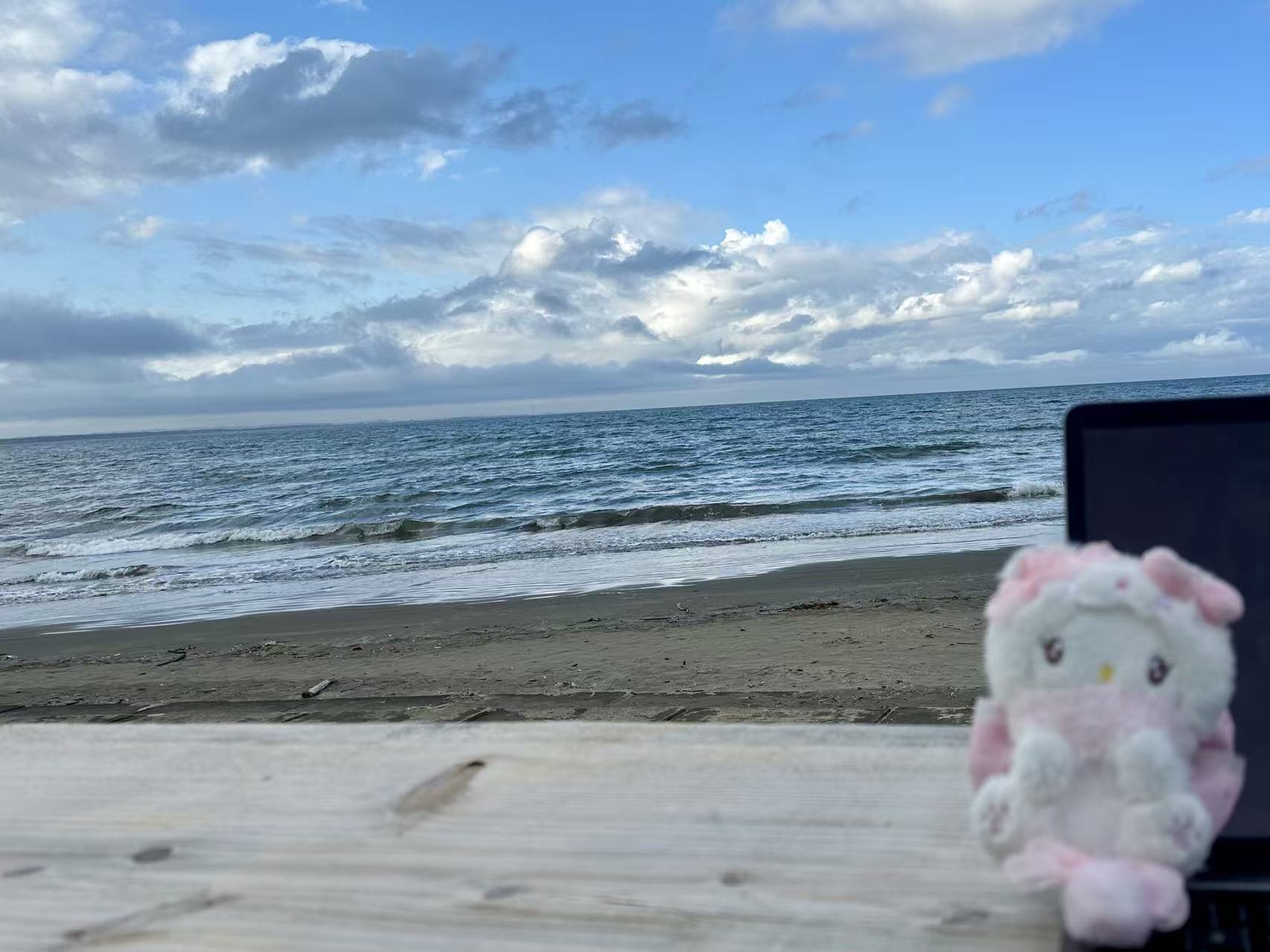 Working by the ocean, laptop open, traveling and making things at the same time