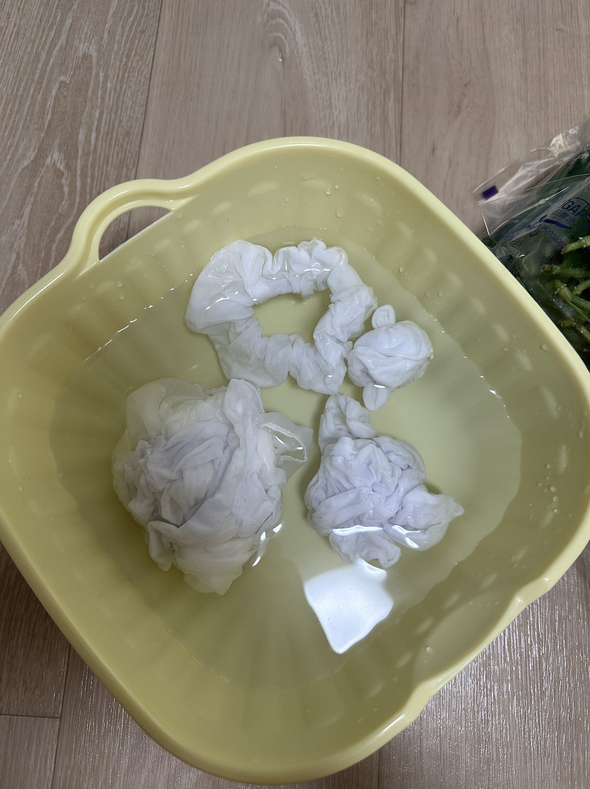 Silk hand-bound with shibori resist, soaking before dyeing