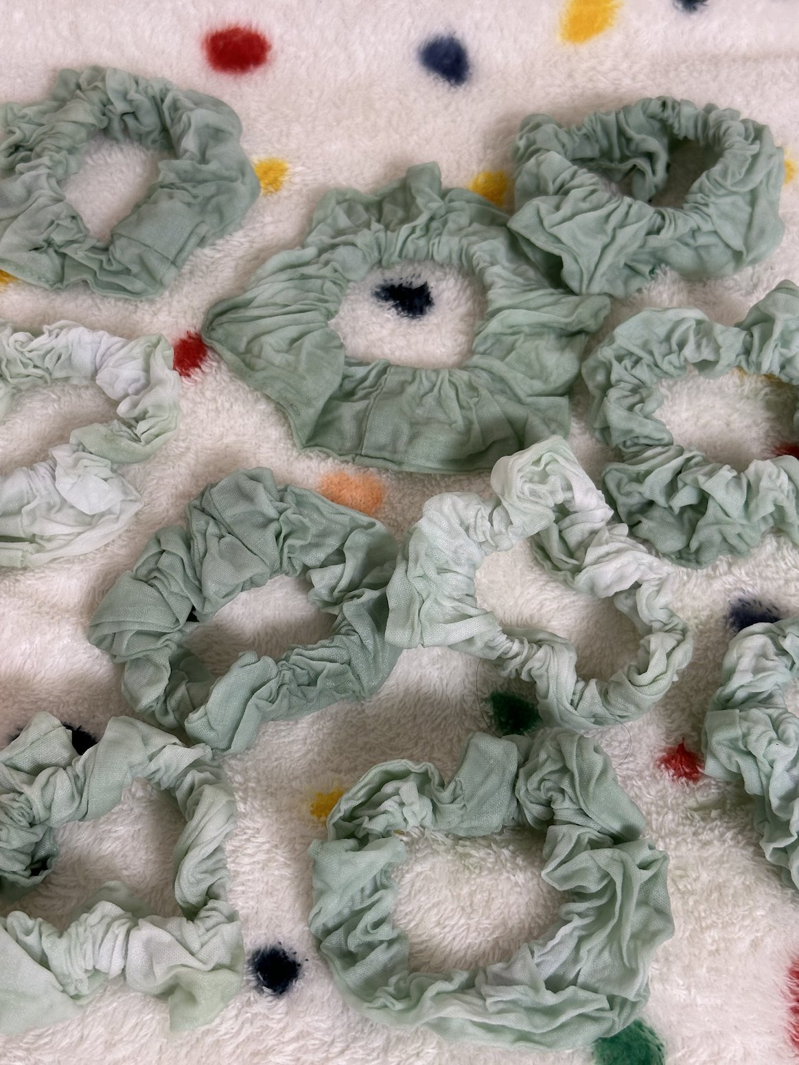 Dyed silk scrunchies drying, pale mint to blue-green